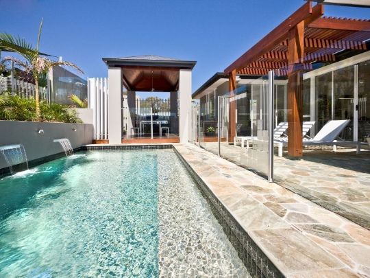 poolside with a semi-frameless glass pool enclosure | Rockhampton Fencing Pros
